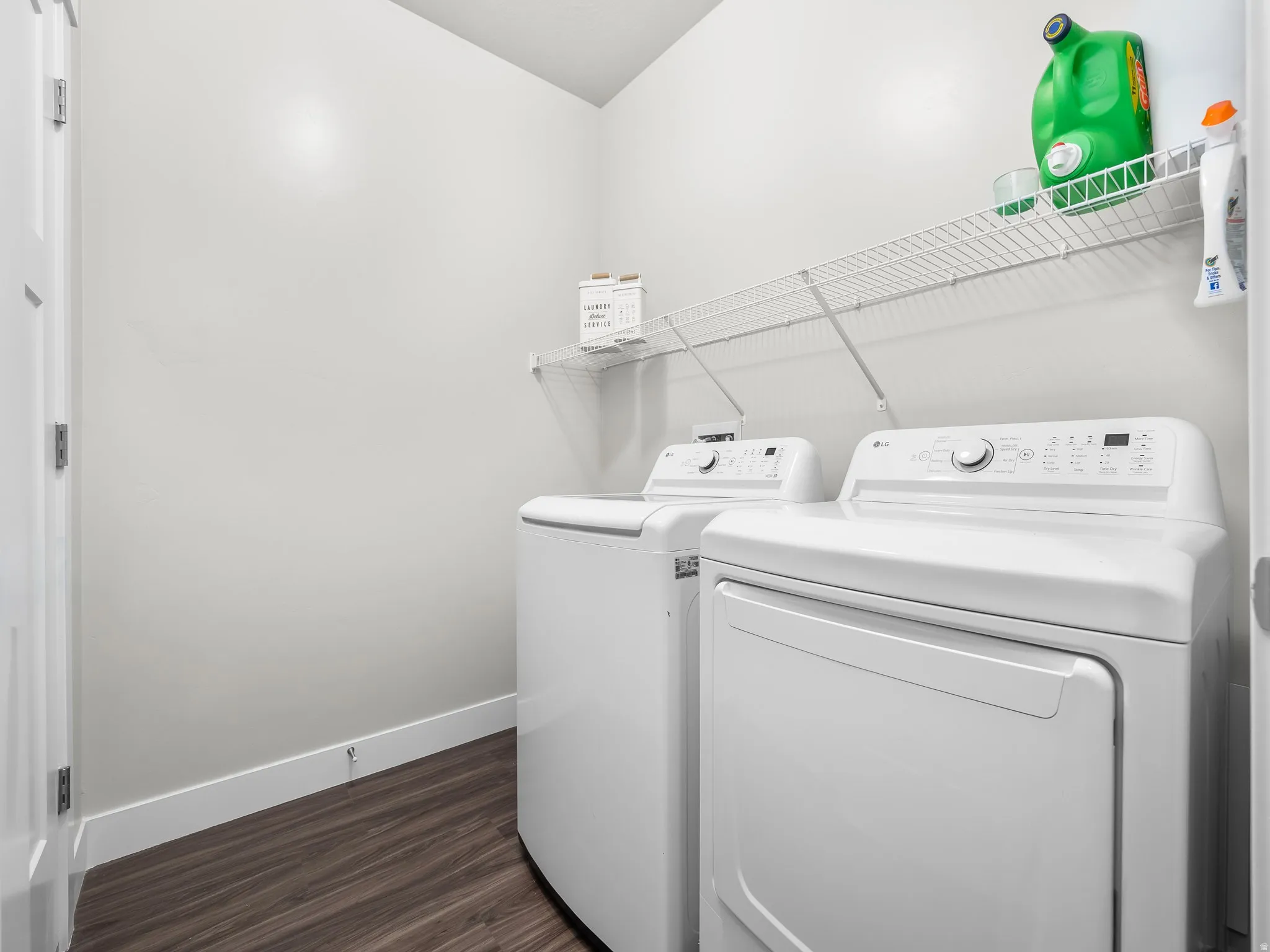 Laundry area featuring washer and dryer and wood-type flooring