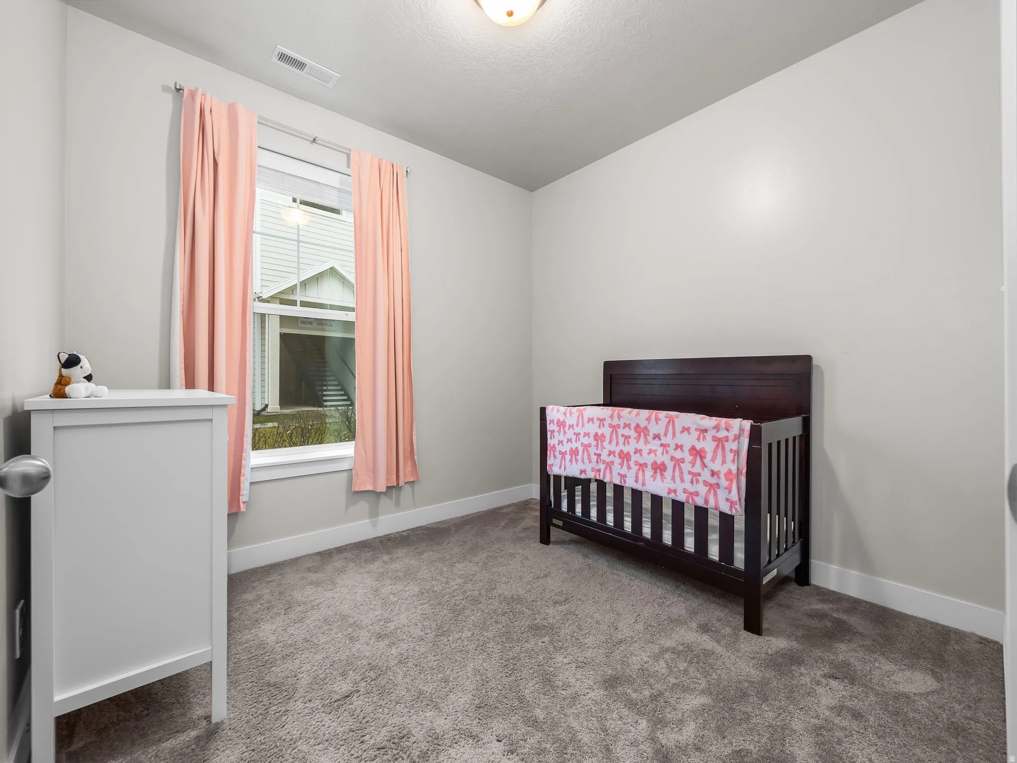 Bedroom with a crib and carpet