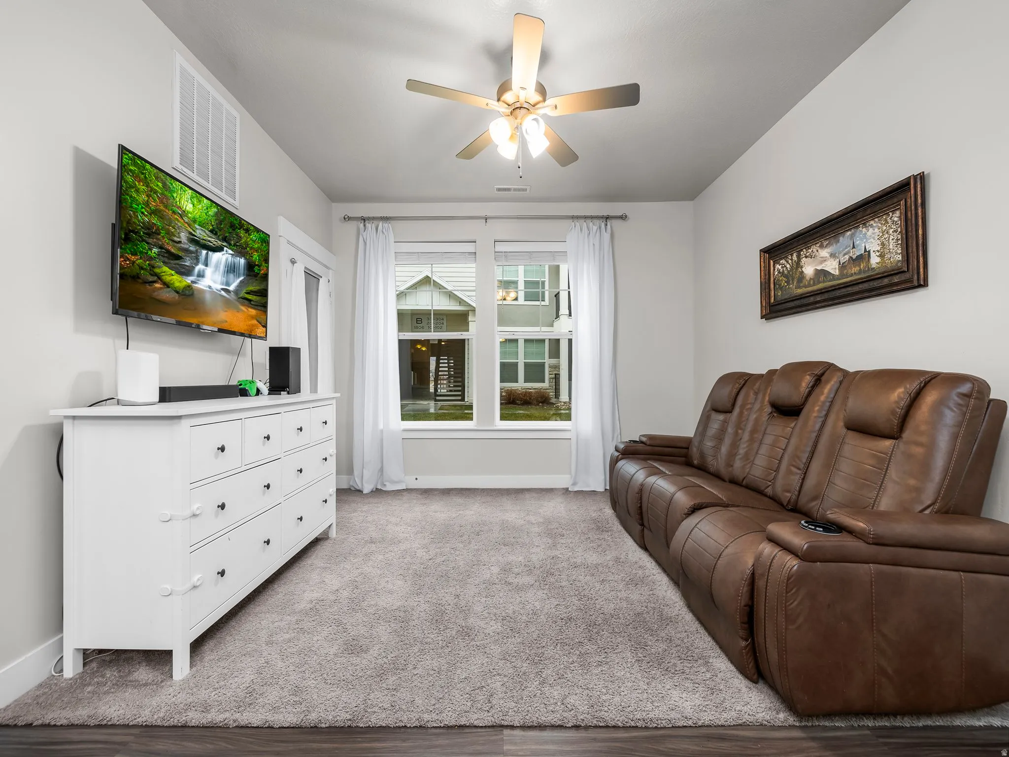 Living room with ceiling fan and carpet floors