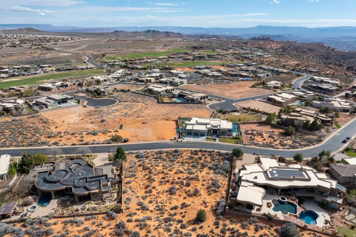View of property location featuring mountains and nearby suburban area
