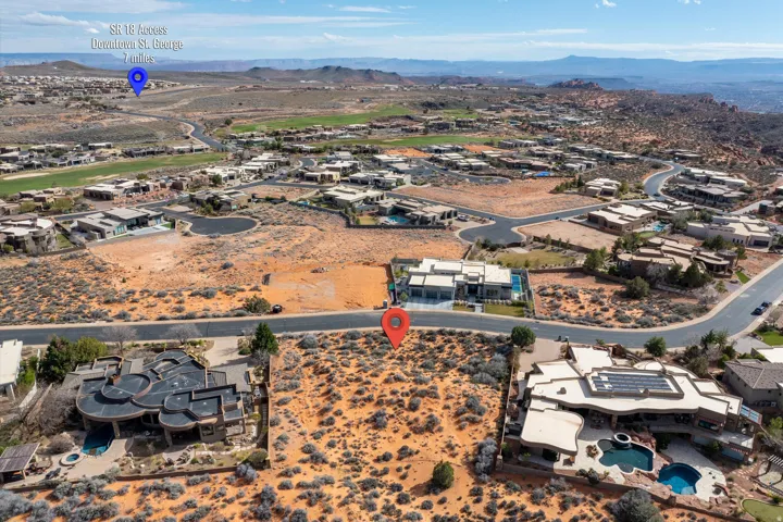Aerial overview of property's location featuring a mountainous background and nearby suburban area