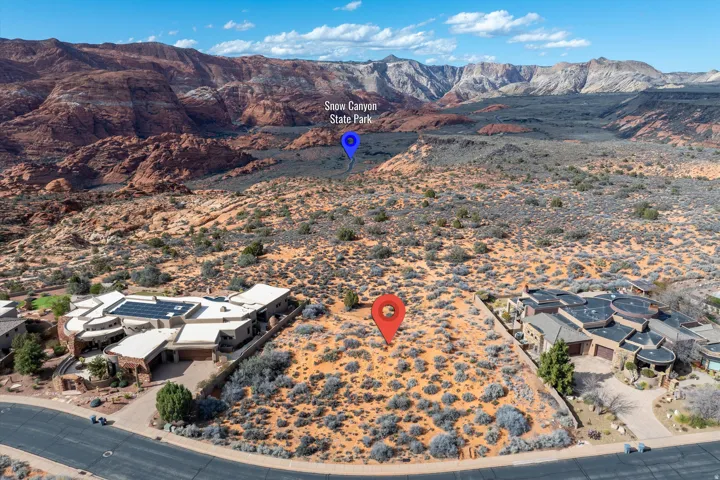 Aerial overview of property's location with a mountainous background and a desert landscape