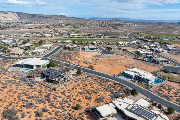 Aerial view of property's location with a mountainous background and nearby suburban area