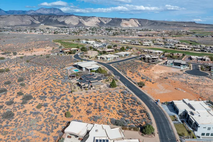 Aerial perspective of suburban area featuring a mountainous background
