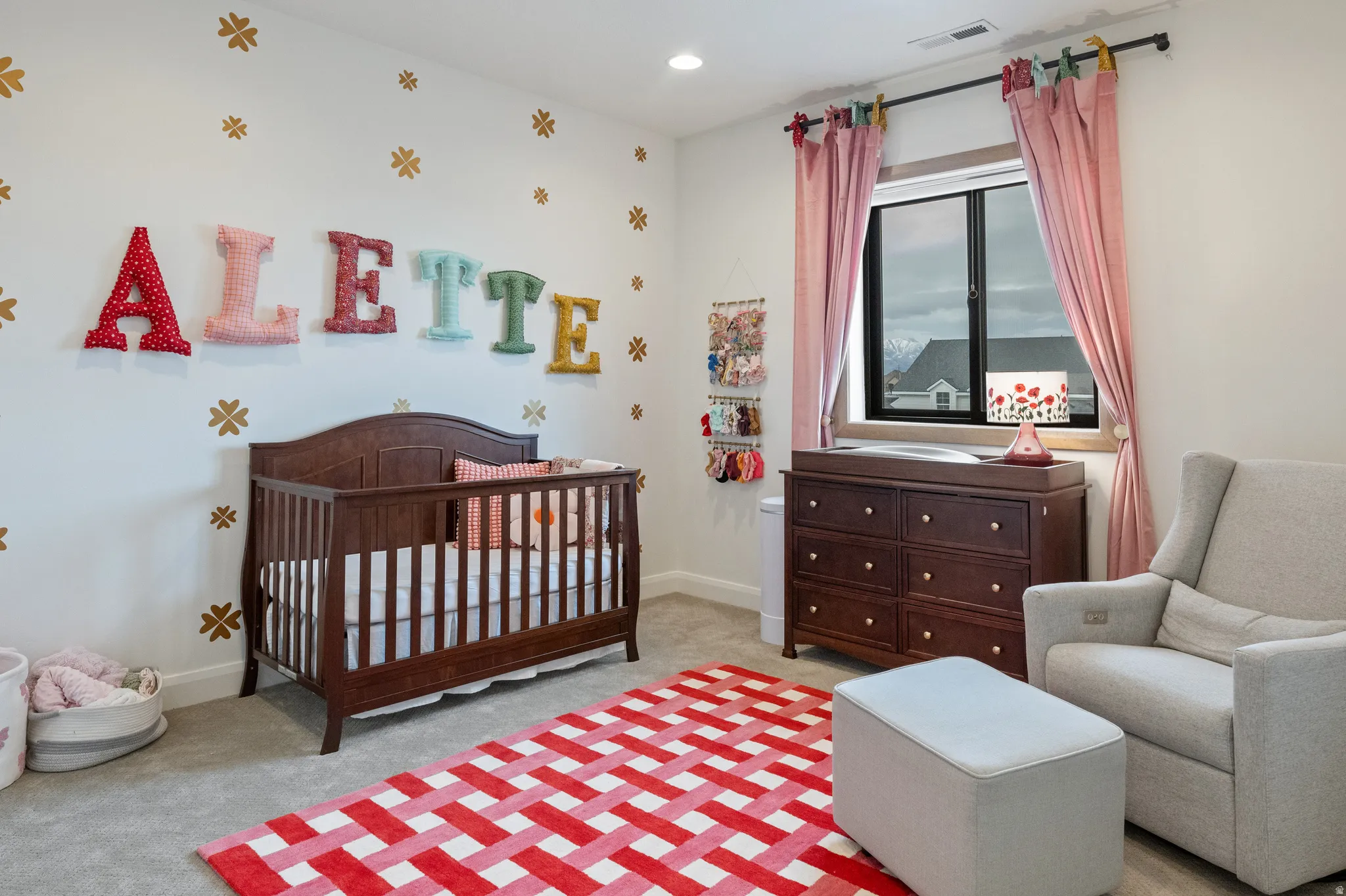 Bedroom 2 with a nursery area, light carpet, and recessed lighting