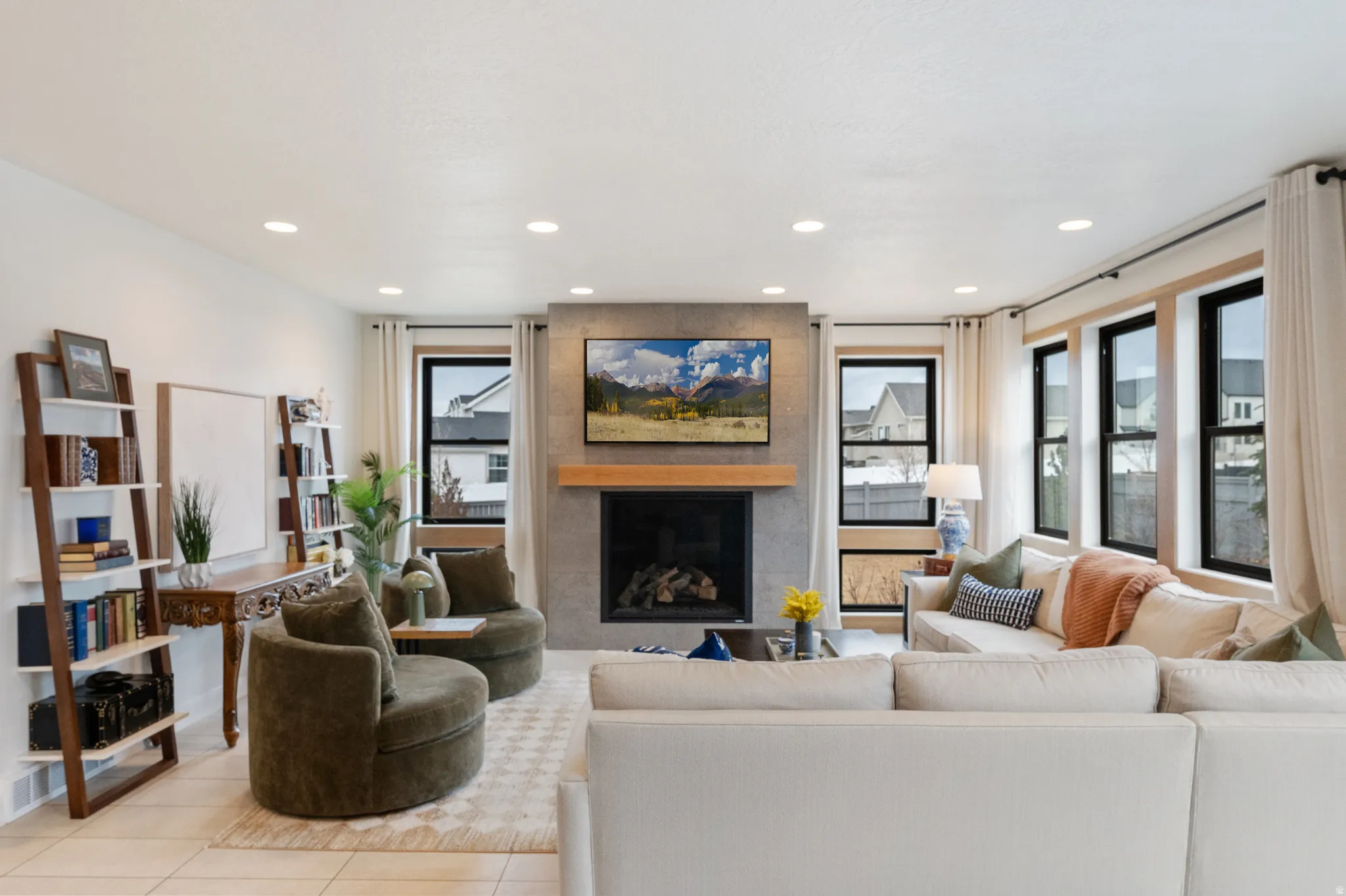 Living area with a fireplace, recessed lighting, and tile patterned flooring