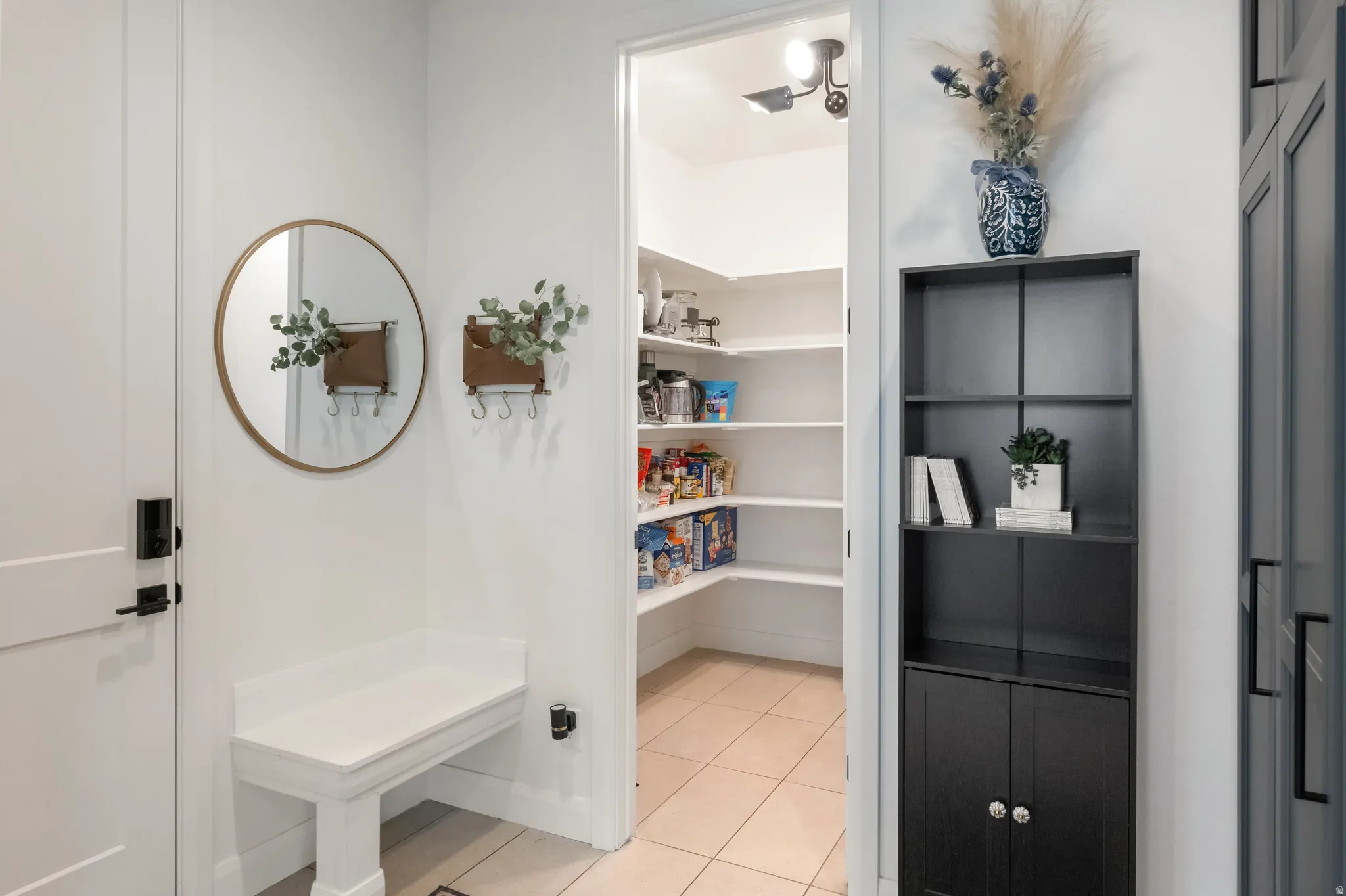 Entrance from the garage with Mud Room, storage cabinets and large walk-in pantry