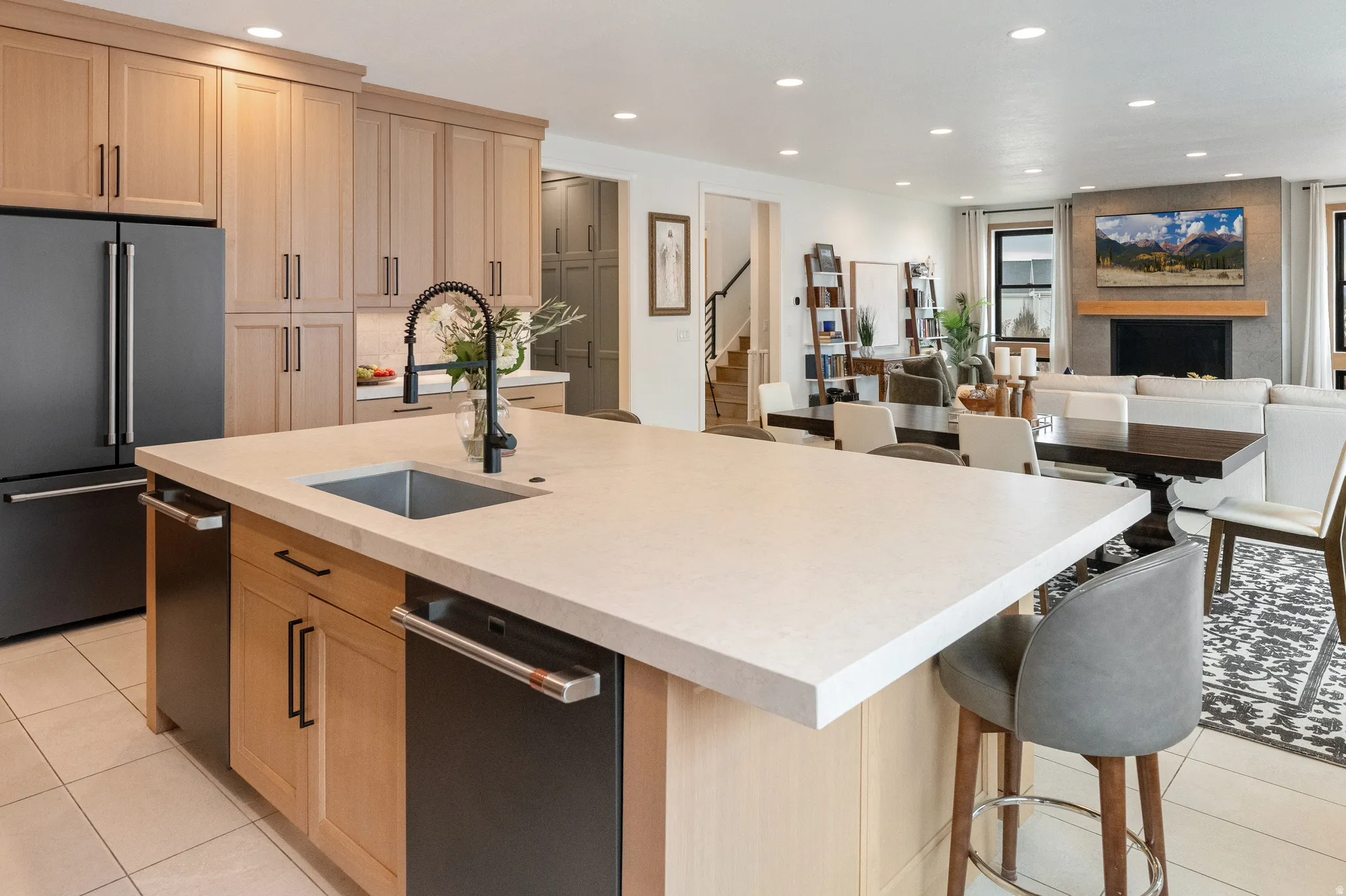 Kitchen with light tile patterned floors, white oak cabinets, recessed lighting, stainless steel appliances, and open floor plan