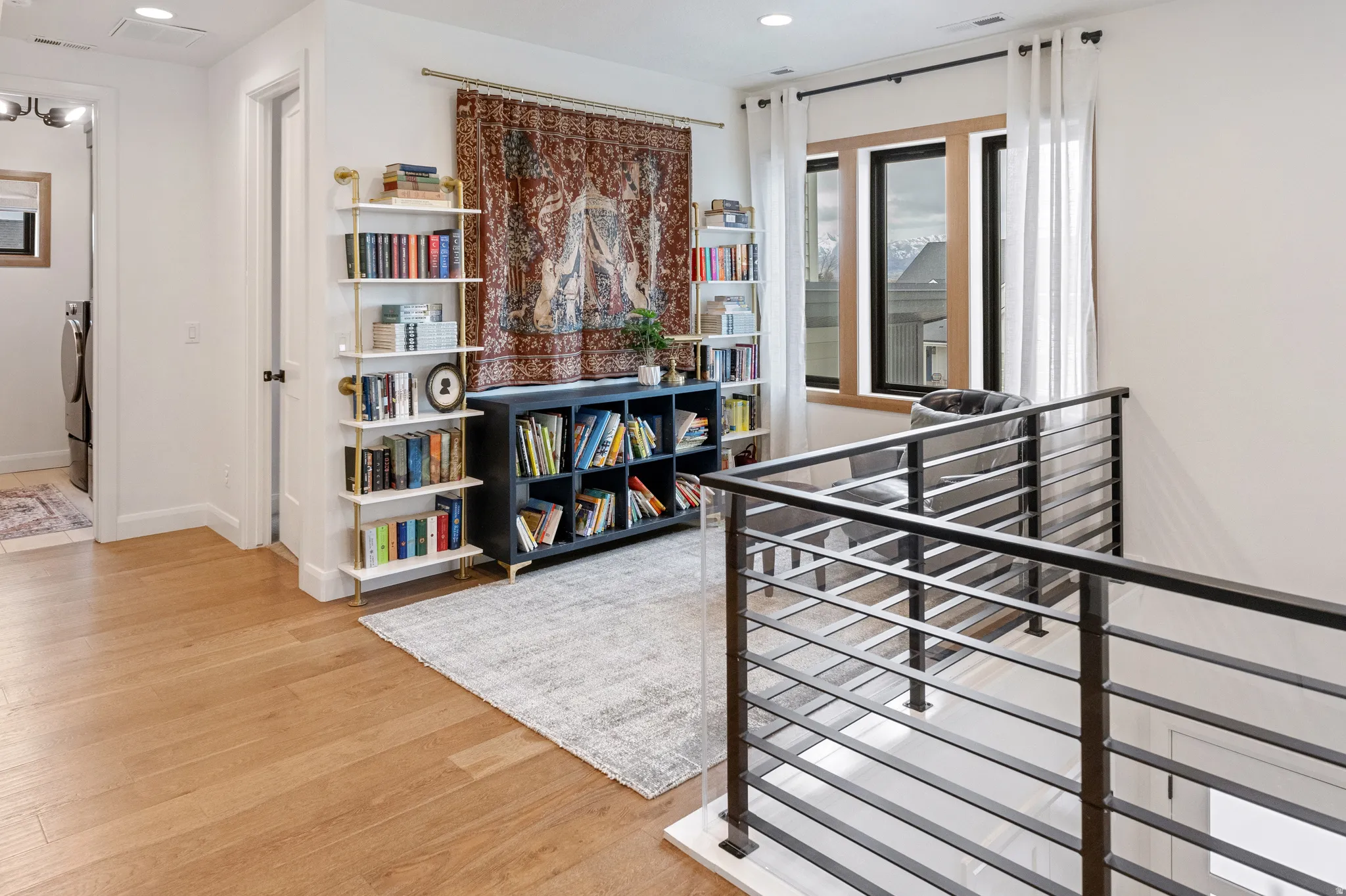 Loft area featuring solid white oak  floors, recessed lighting, and an upstairs landing