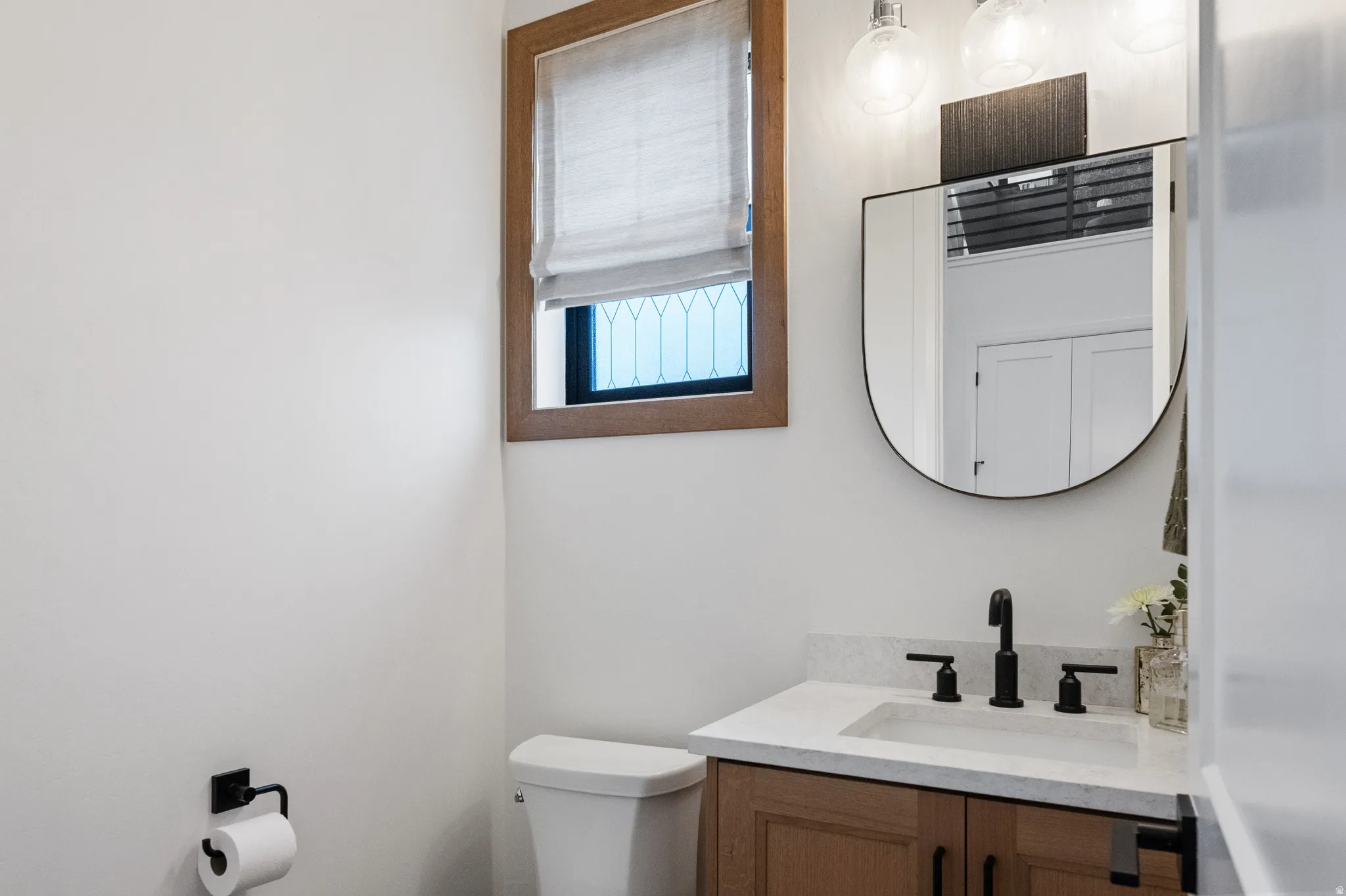 Half bath with vanity and toilet