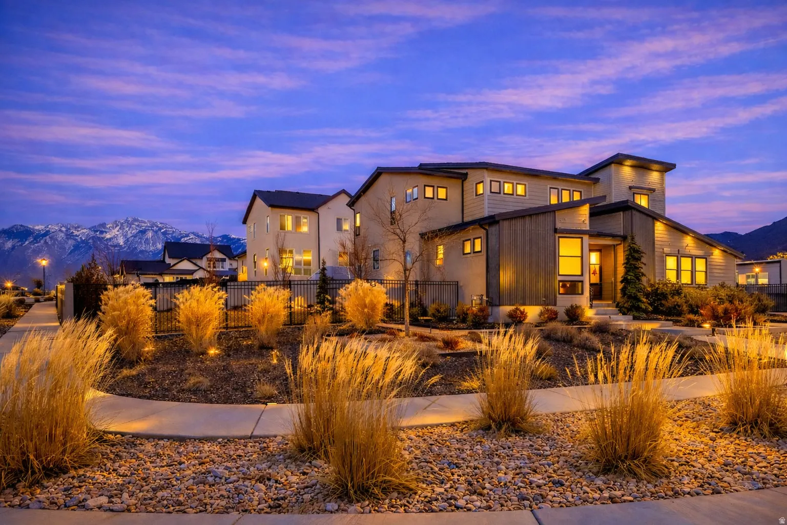 View of front facade with mountain views and a fully fenced yard