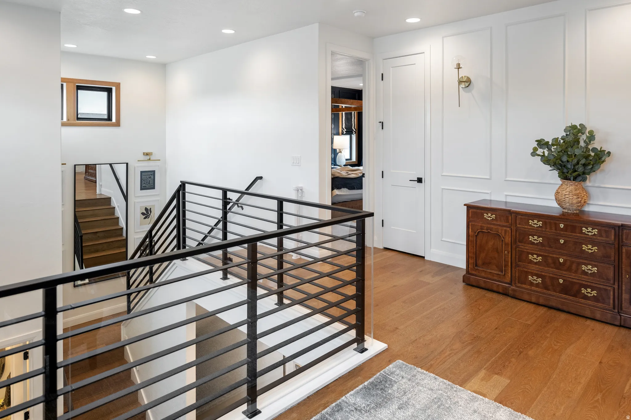 Hall with an upstairs landing, recessed lighting, and solid white oak flooring