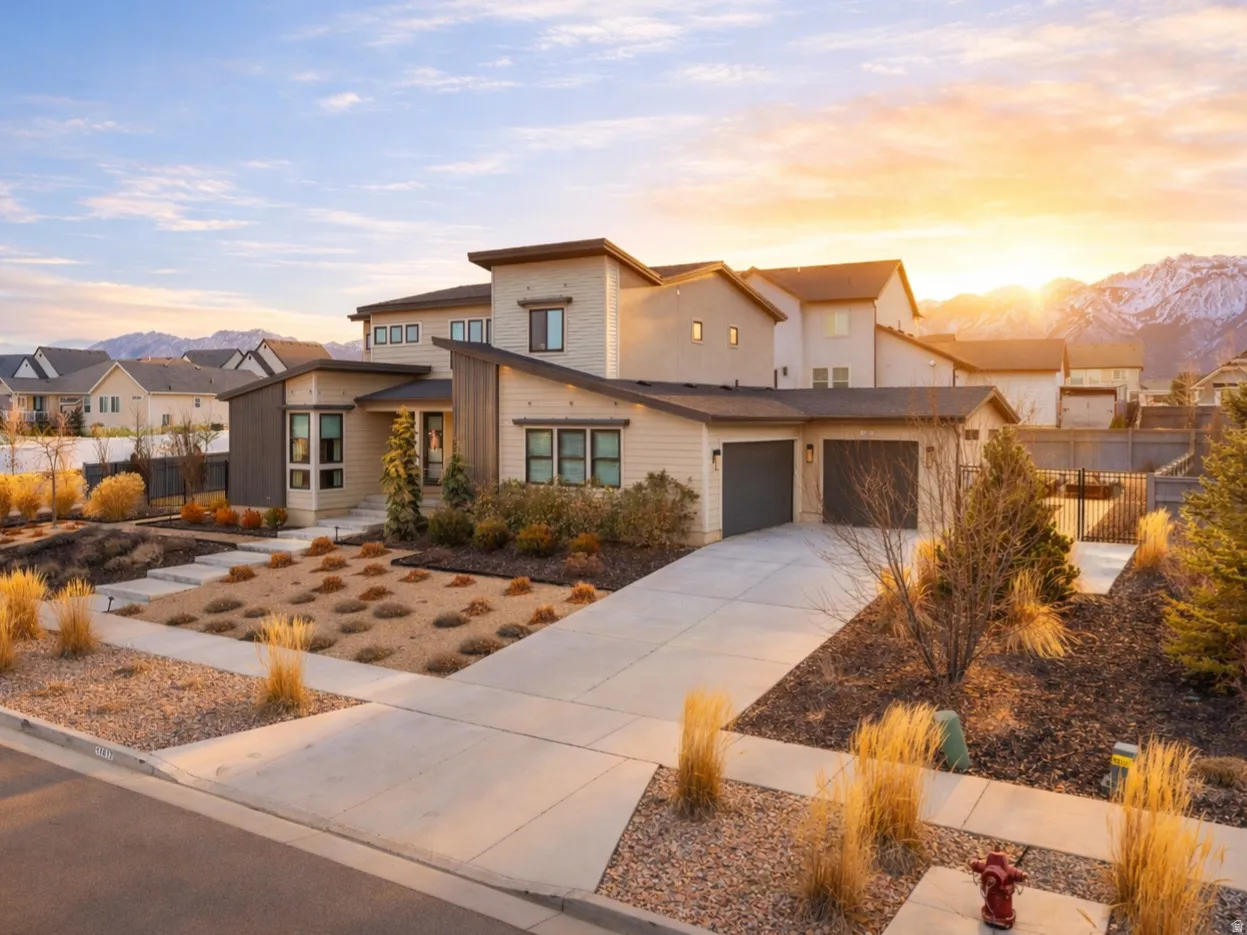 Contemporary home featuring a residential view, driveway, and a mountain view