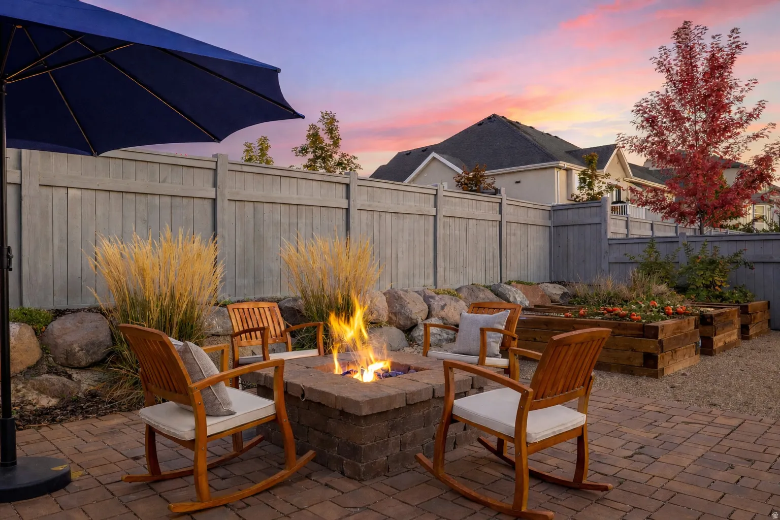 Patio terrace at dusk with a patio area, a fenced backyard, and an outdoor fire pit