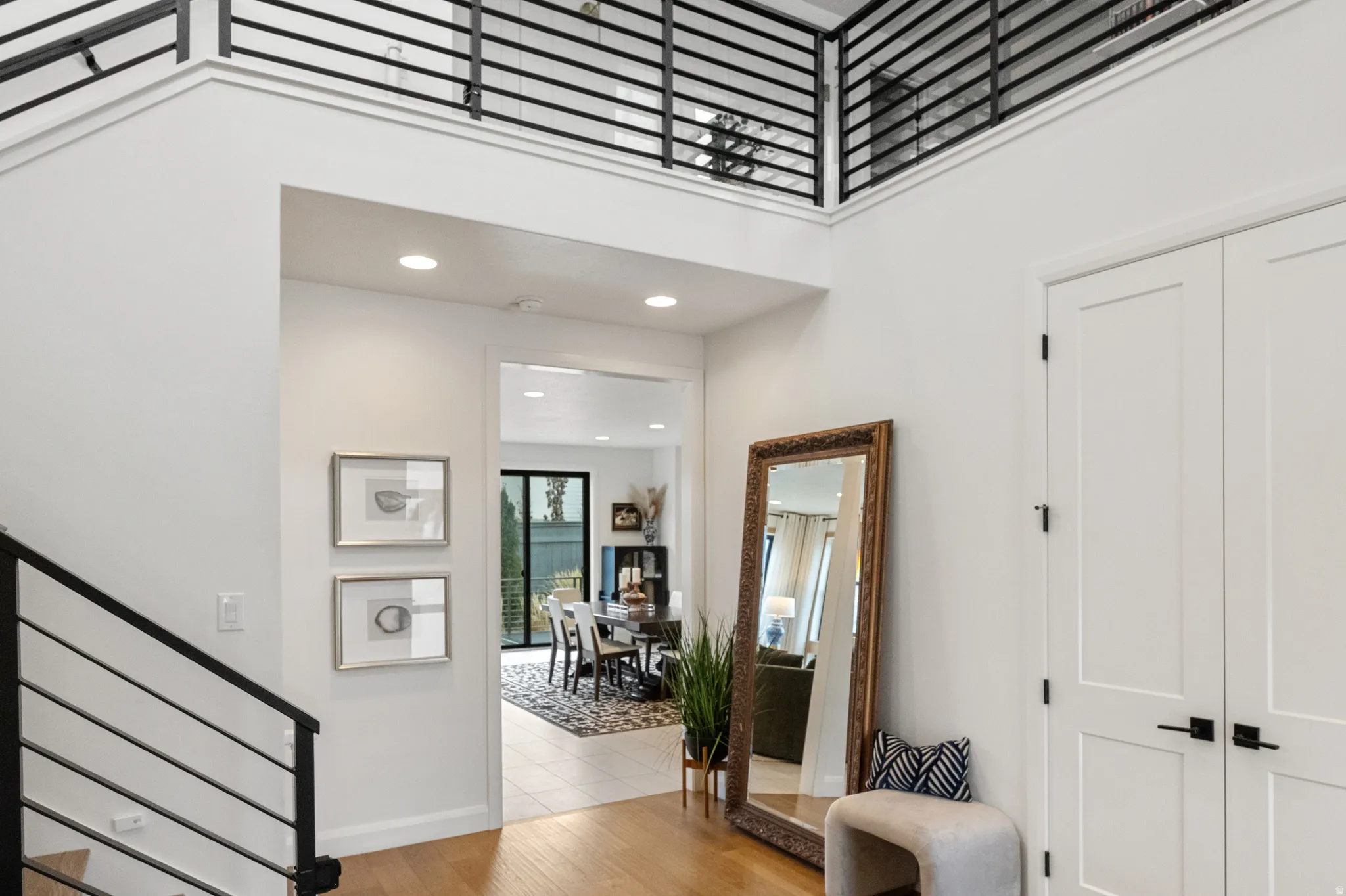 Entrance foyer with a high ceiling, light solid wood white oak flooring, and recessed lighting