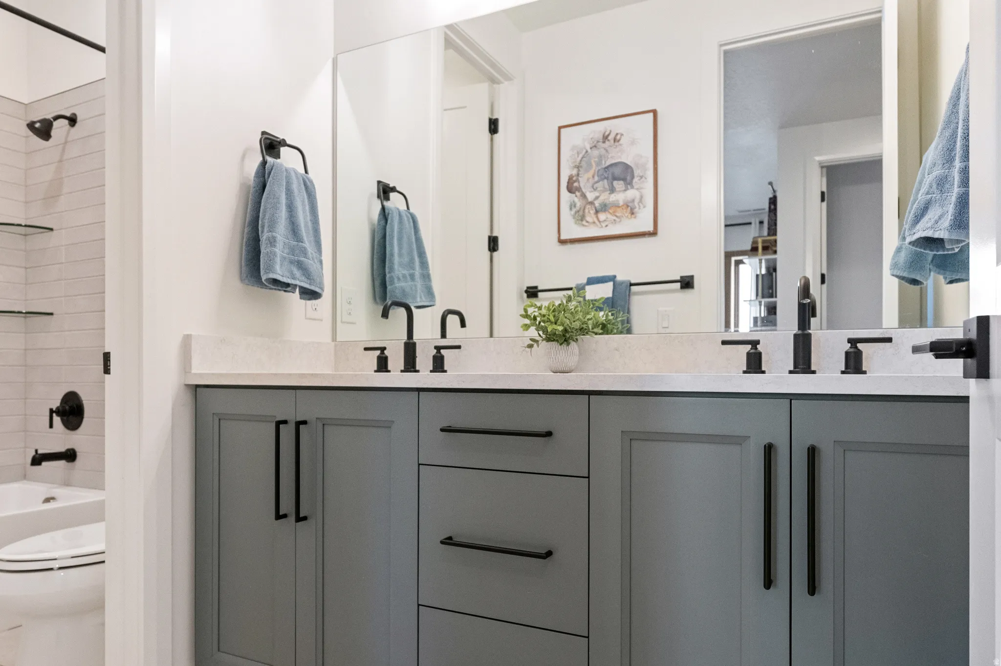 Bathroom with washtub / shower combination and double vanity