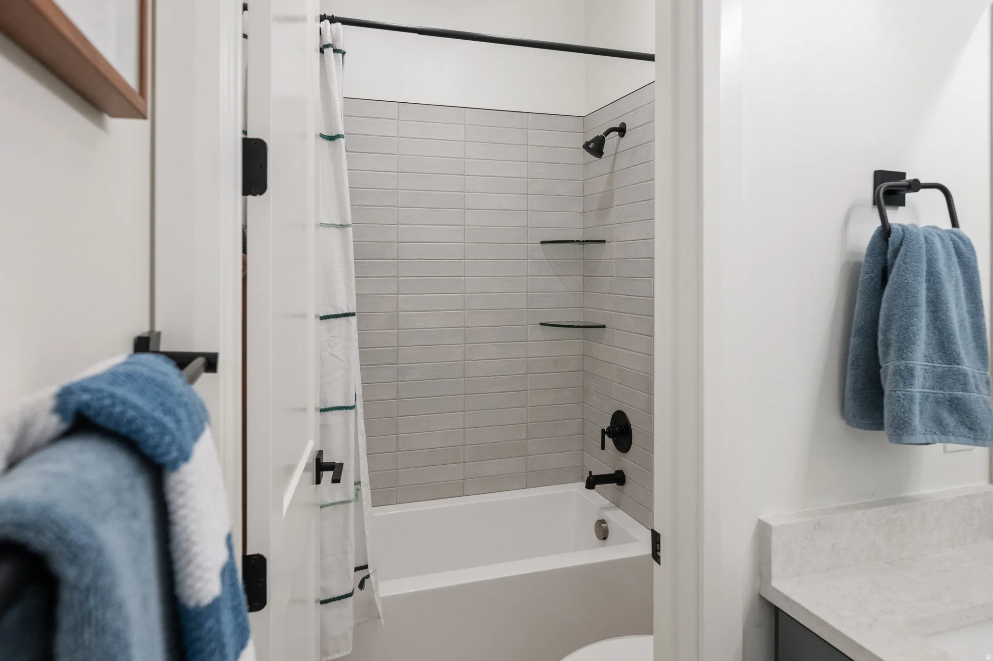Bathroom with shower / bath combo with shower curtain and double vanity
