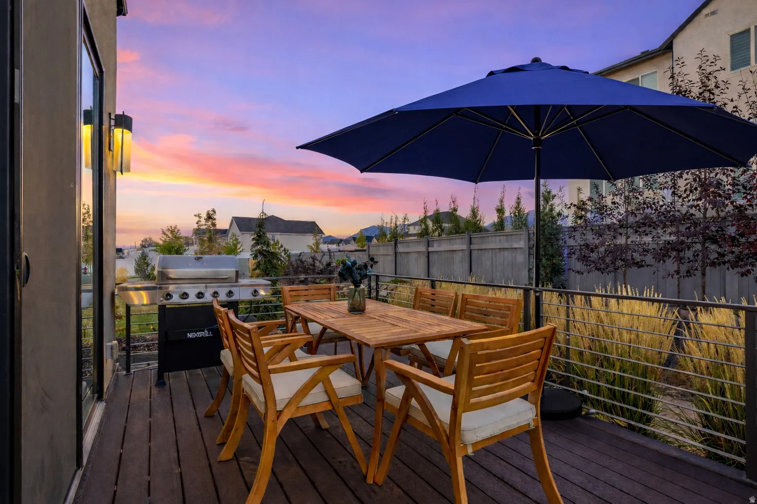 Deck at dusk featuring outdoor dining area and area for grilling