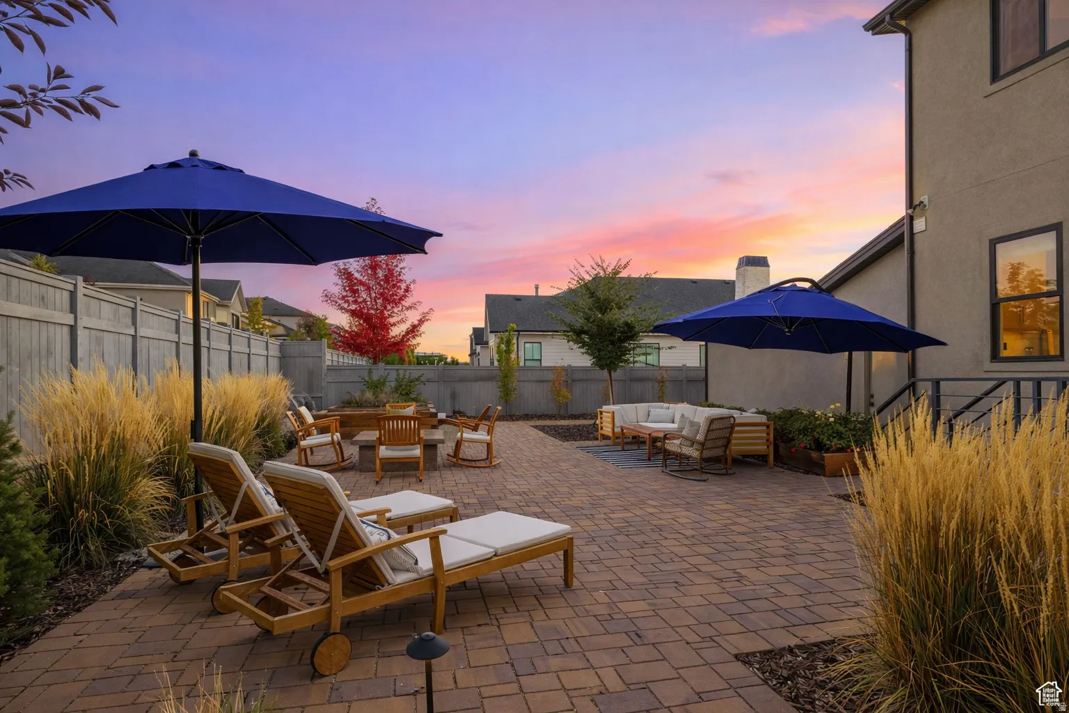 Patio terrace at dusk with outdoor seating, a patio area, and a fenced backyard