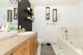 Bathroom featuring a bath, vanity, and light tile patterned floors