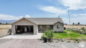 Front of house featuring gravel driveway and an attached garage