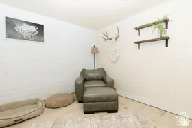 Sitting room with baseboards and wood finished floors