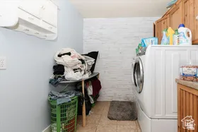 Laundry room with light tile patterned floors