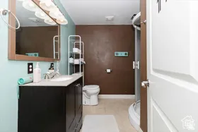 Full bath featuring vanity and light tile patterned floors