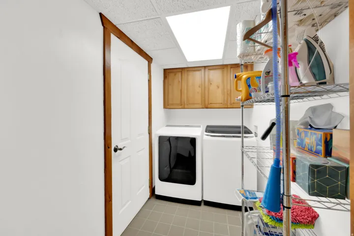 Laundry area with a paneled ceiling, cabinet space, and washer and dryer