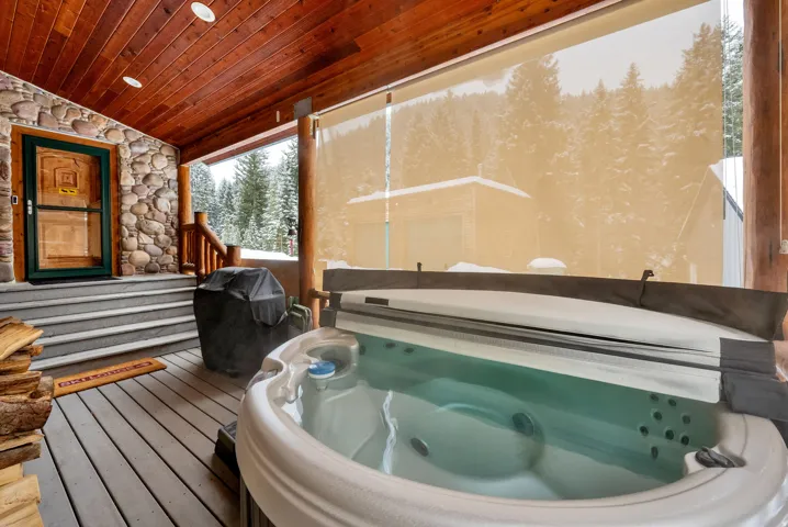 Sunroom with a jacuzzi, lofted ceiling, and a relaxing sauna
