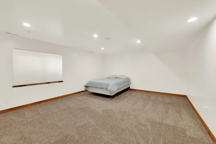 Bedroom with recessed lighting and light colored carpet