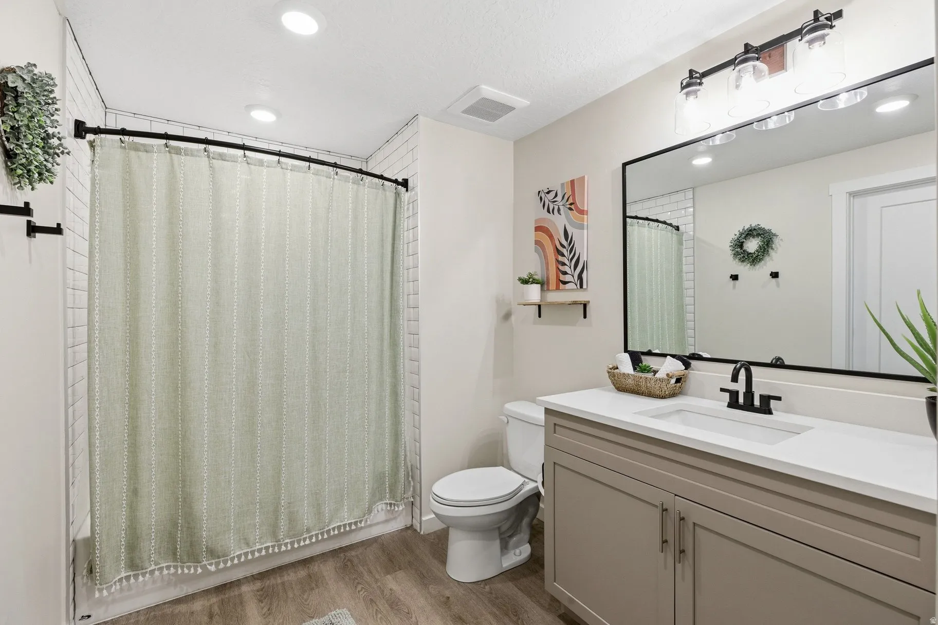 Full bathroom with vanity, light wood-style floors, recessed lighting, and shower / tub combo with curtain