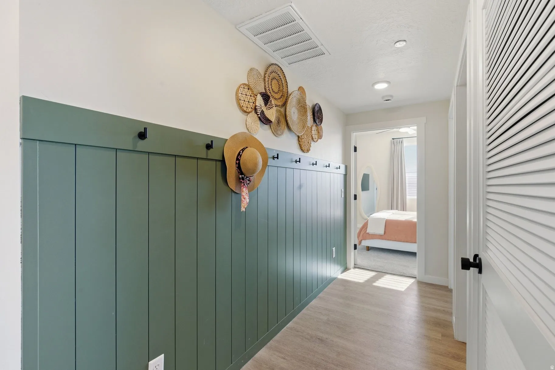 Hallway featuring light wood finished floors