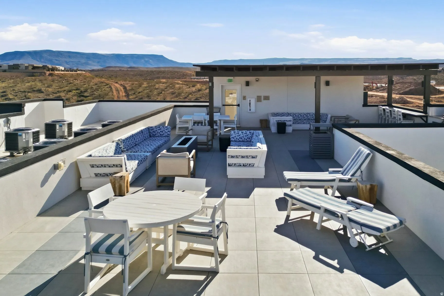 View of patio featuring a mountain view, an outdoor fire pit, and an outdoor living / dining area