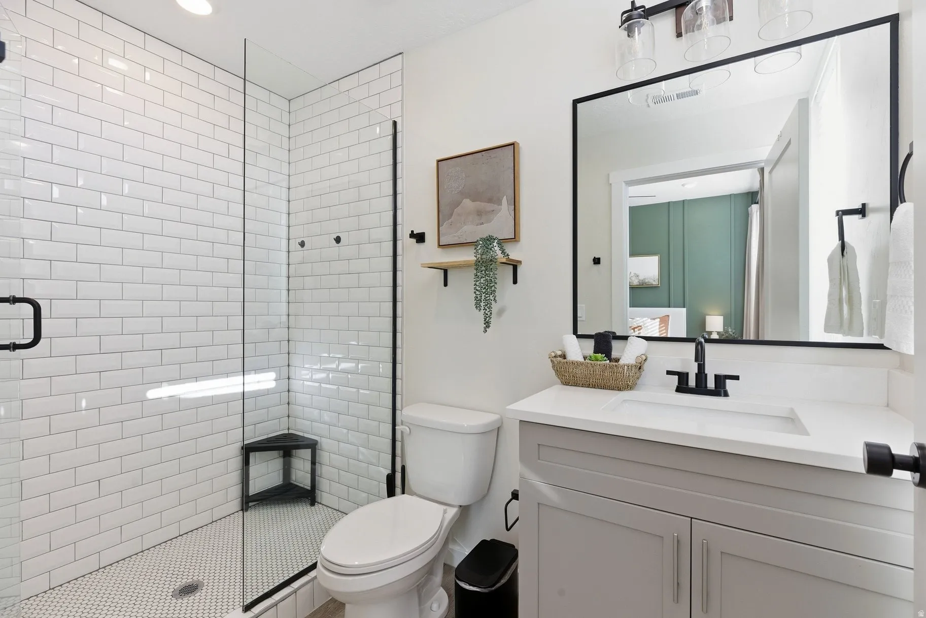 Ensuite bathroom with vanity, a stall shower, and recessed lighting