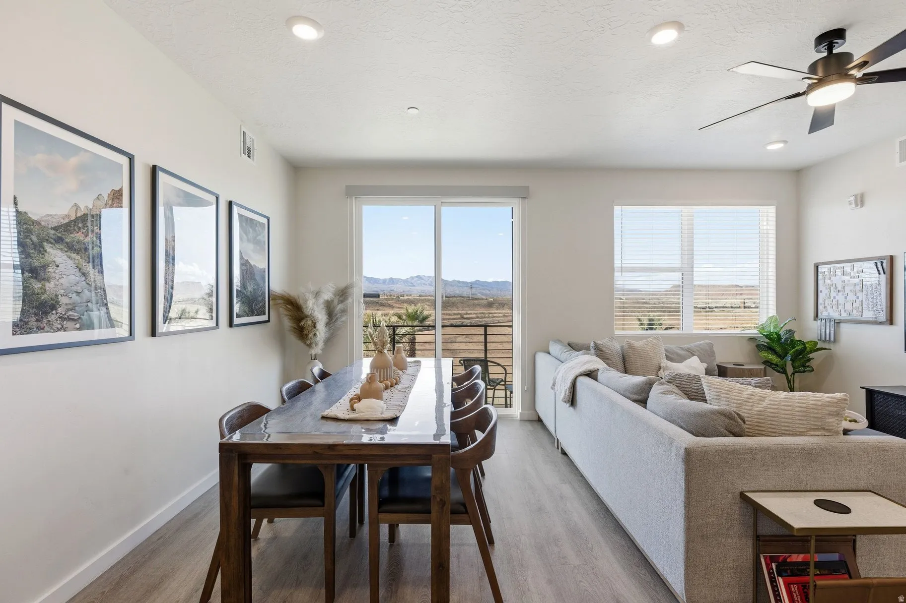 Dining space featuring ceiling fan, light wood-style flooring, a textured ceiling, recessed lighting, and a mountain view