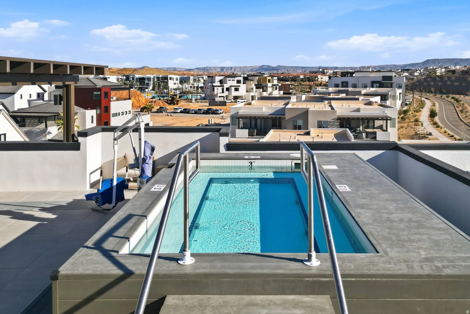 Community pool featuring a patio area, a mountain view, and a residential view