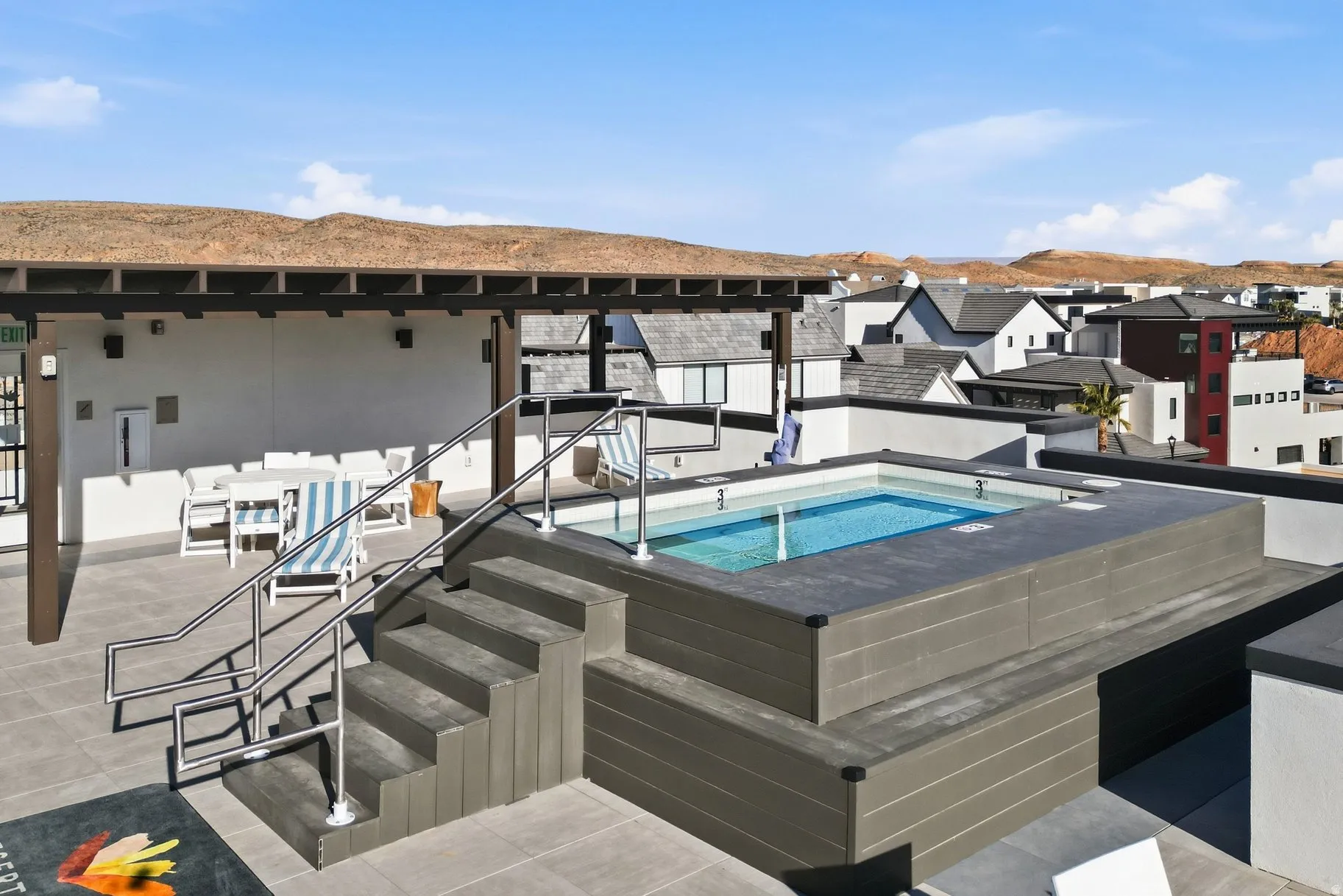 View of swimming pool featuring patio surround, a mountain view, a community hot tub, and a swimming pool