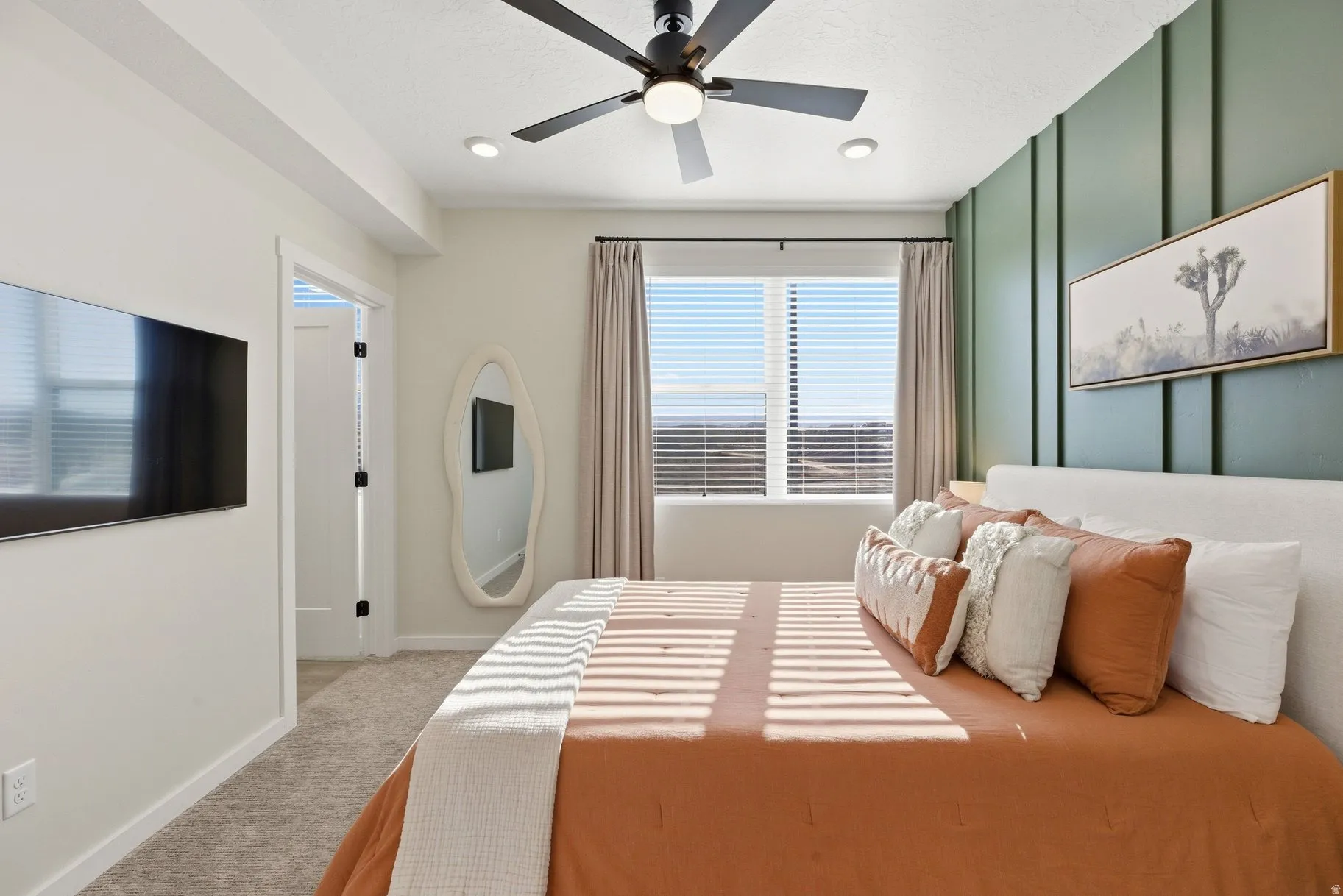 Bedroom with light colored carpet and ceiling fan