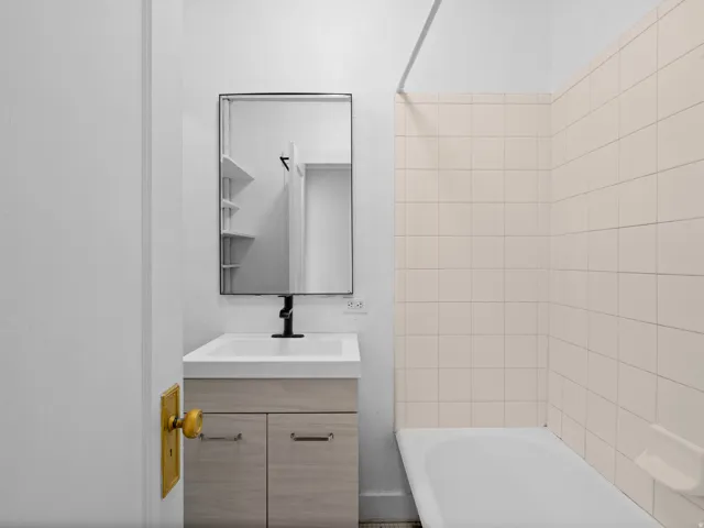 Full bath featuring vanity and bathing tub / shower combination