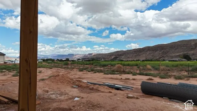 Expansive terrain with distant mountains and agricultural fields
