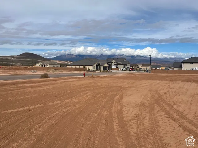 View of mountain backdrop featuring nearby suburban area