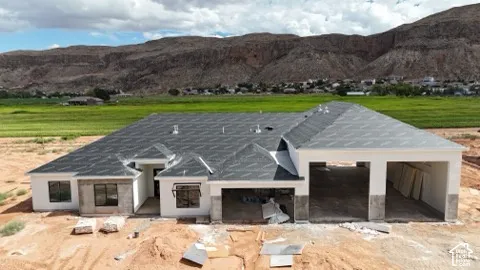 Newly constructed residence featuring a dark shingle roof and a multi-car garage