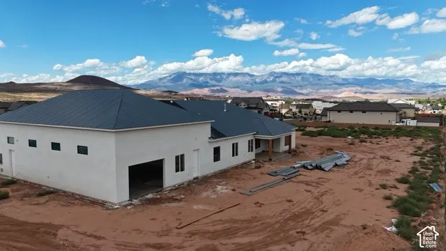 White stucco exterior with a dark metal roof