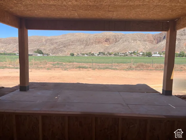 Covered patio with a concrete slab, framed by visible structural wood elements