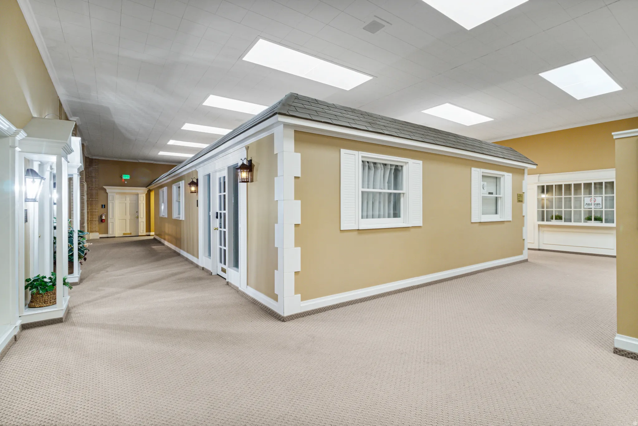Hallway with carpet floors and baseboards