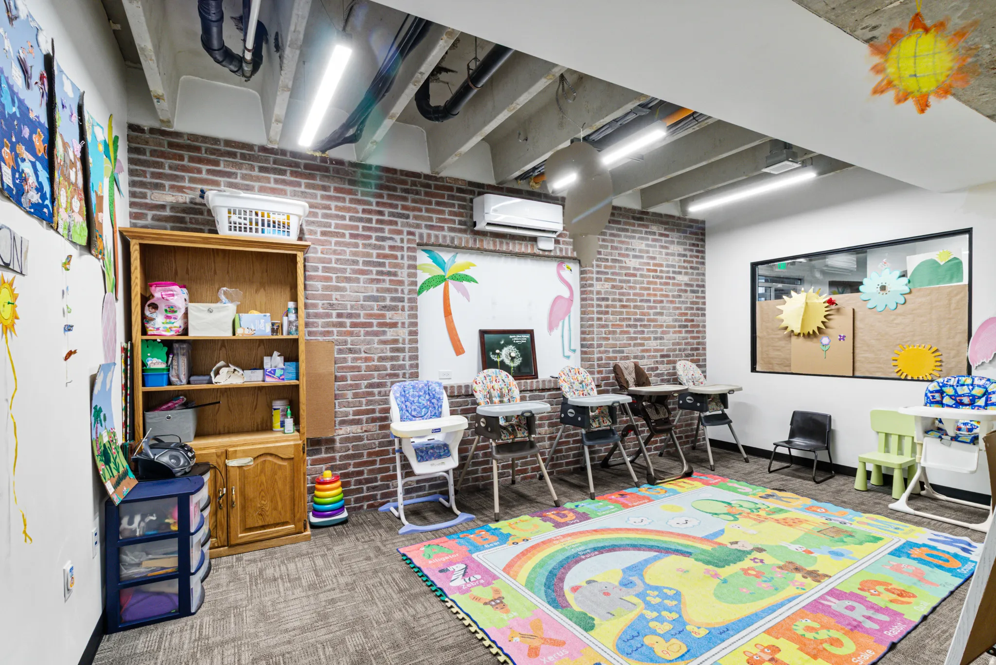 Game room with brick wall and a mini split for heating / cooling