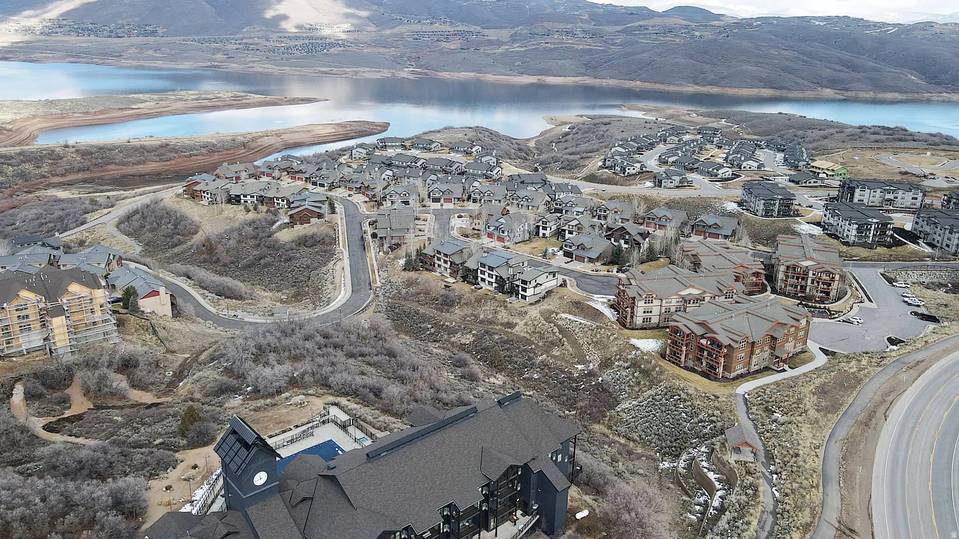 View of property location with a water and mountain view and nearby suburban area