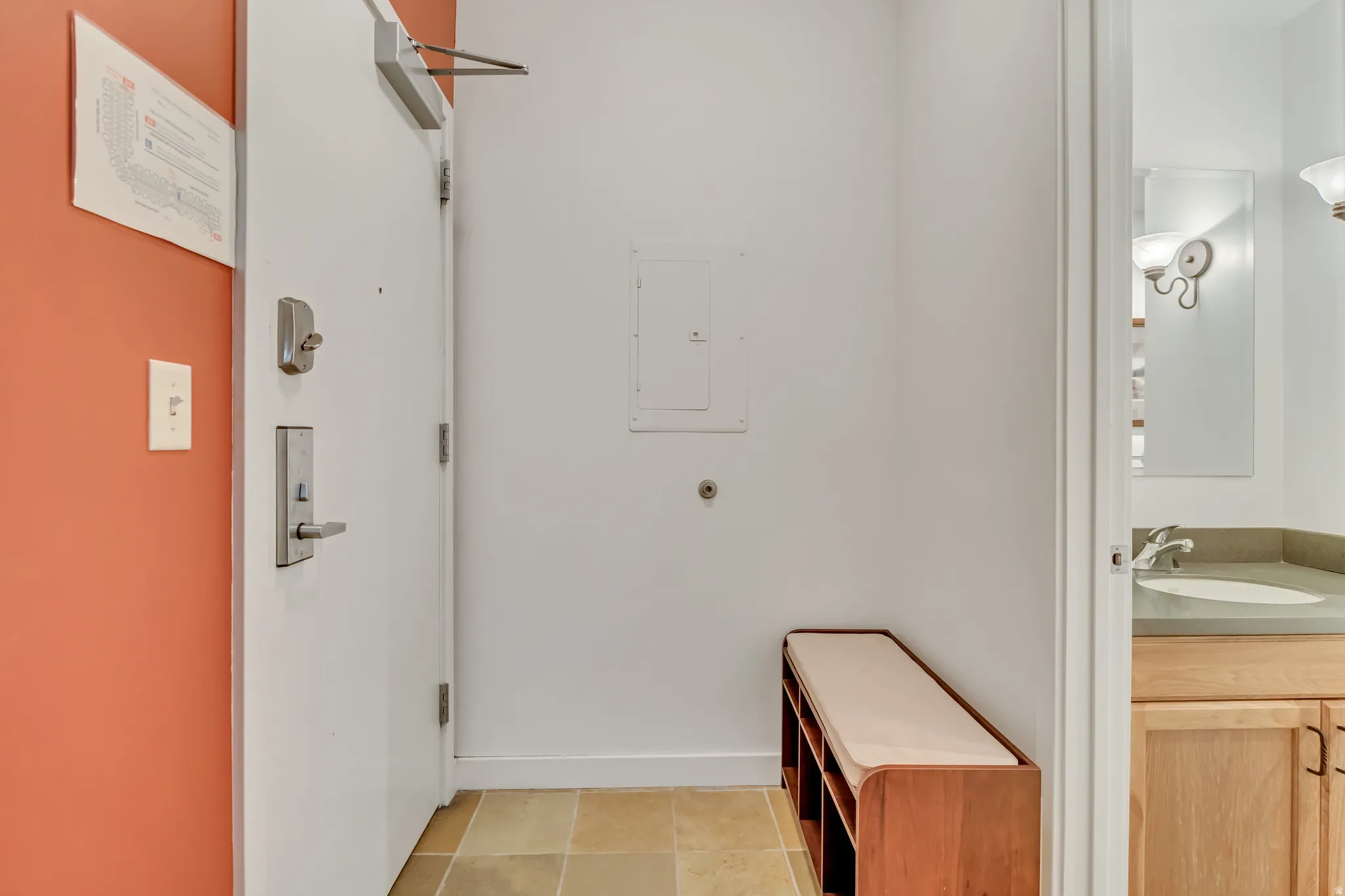 Bathroom featuring vanity, electric panel, and light tile patterned floors