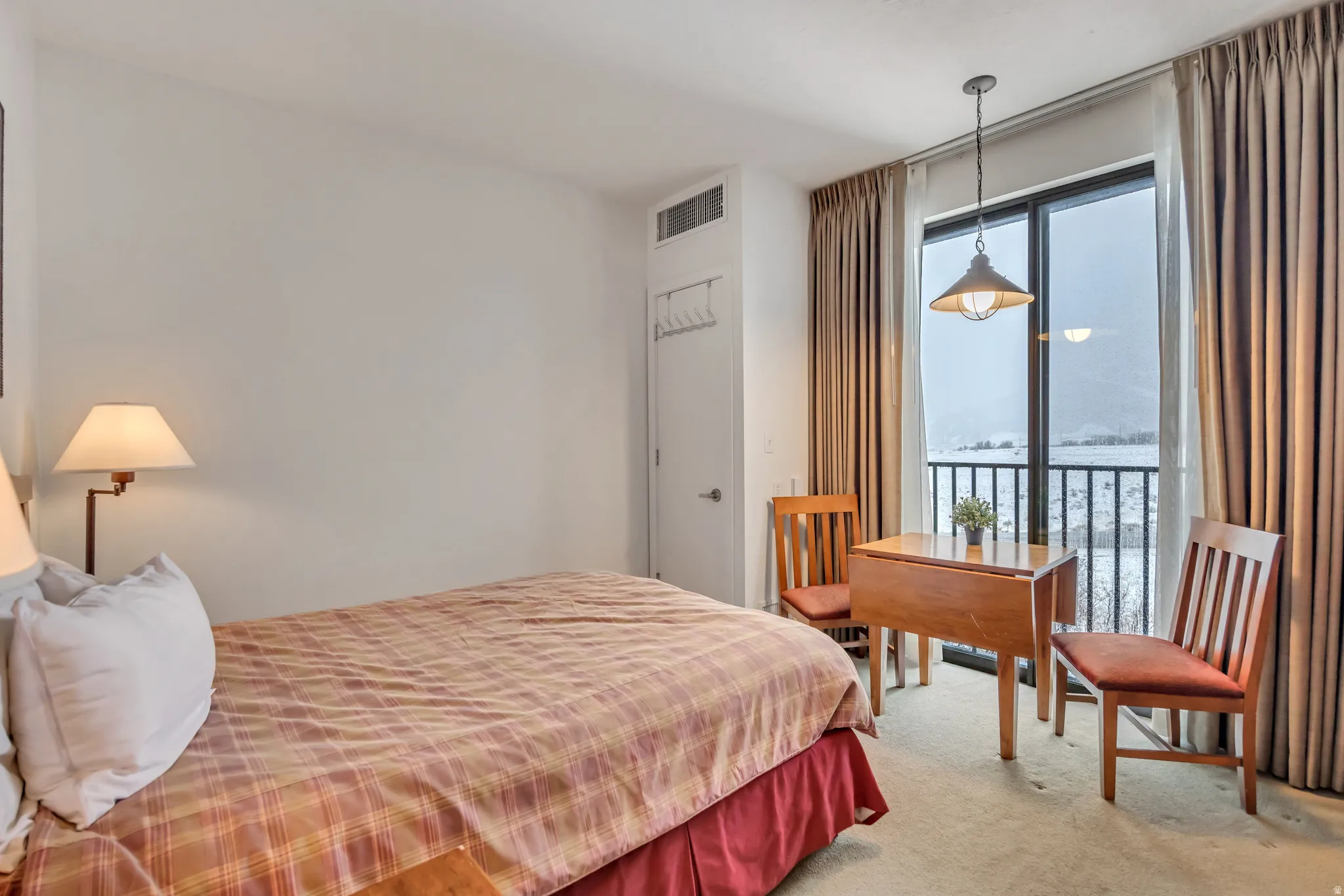 Carpeted bedroom featuring access to outside and a water view